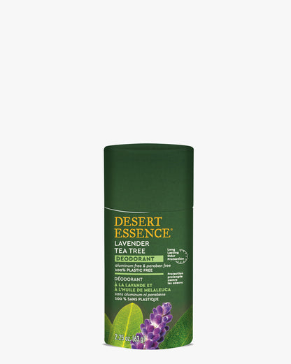 Tea Tree Lavender Deodorant in a dark green eco-friendly paperboard tube featuring purple lavender and green leaf imagery. Desert Essence natural deodorant with dual-language labeling against white background.