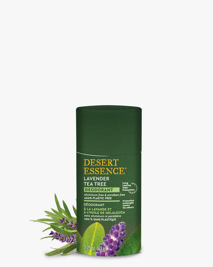 Tea Tree Lavender Deodorant in dark green eco-friendly paper tube with Desert Essence branding, displayed alongside fresh lavender sprigs and tea tree leaves, highlighting its natural ingredients and plastic-free packaging