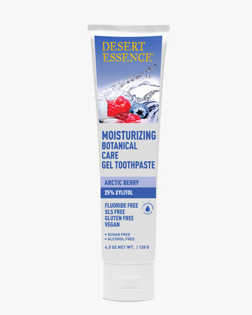 Desert Essence Moisturizing Gel Toothpaste - Arctic Berry in a white tube against white background, featuring blue text and splash graphics with red berries. Product highlights fluoride-free, vegan, and botanical care properties with 25% xylitol.