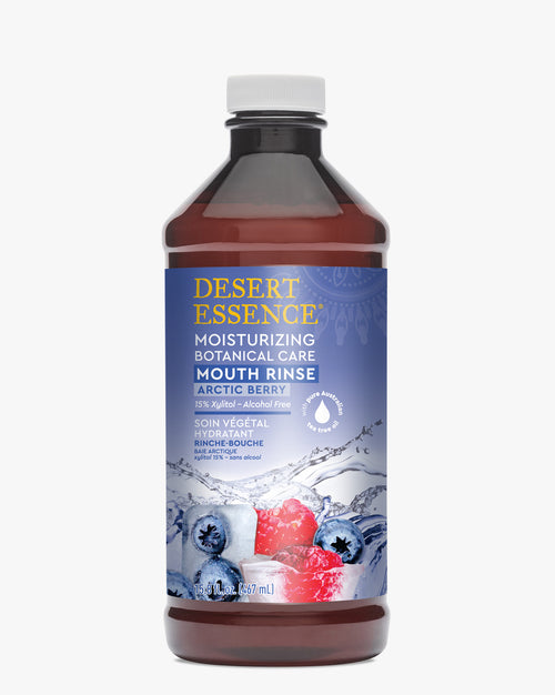 Desert Essence Moisturizing Mouth Rinse Arctic Berry in a brown bottle with blue label featuring water splash and berry graphics. White cap seals the botanical mouthwash containing natural ingredients for oral health and fresh breath.