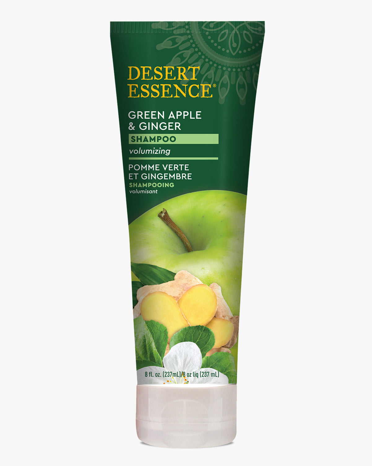 Desert Essence Green Apple & Ginger Shampoo bottle featuring a dark green tube design with bright yellow text, showcasing fresh green apple and ginger root imagery against natural leaf accents. The volumizing shampoo packaging displays both English and French text.