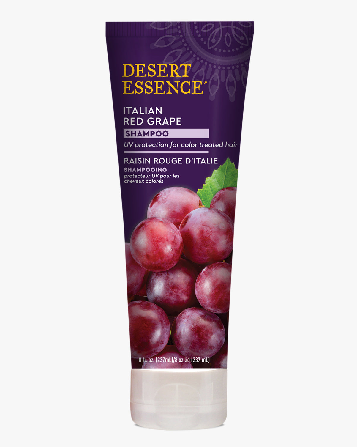 Desert Essence Italian Red Grape Shampoo bottle featuring fresh red grapes on deep purple packaging, designed for color-treated hair with UV protection. The natural-looking product tube displays English and French text against a mandala pattern background.