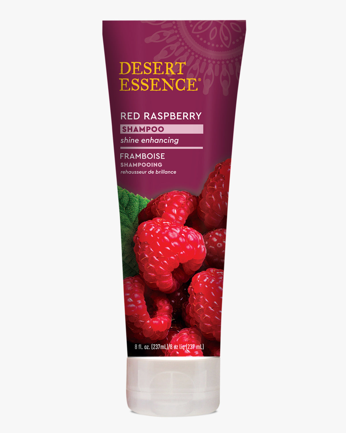 Desert Essence Red Raspberry Shampoo bottle featuring fresh red raspberries on a burgundy background, with gold and white text highlighting shine-enhancing properties and organic ingredients.