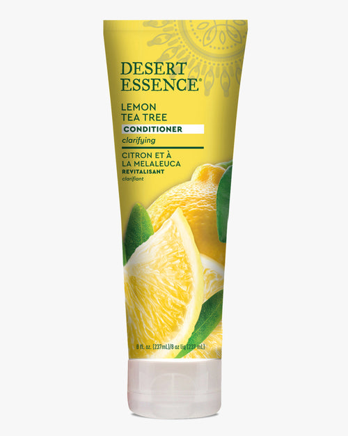 Desert Essence Lemon Tea Tree Conditioner in a yellow tube featuring fresh lemon slices and green leaves, showcasing a natural hair care product for clarifying and revitalizing hair with tea tree and citrus ingredients.