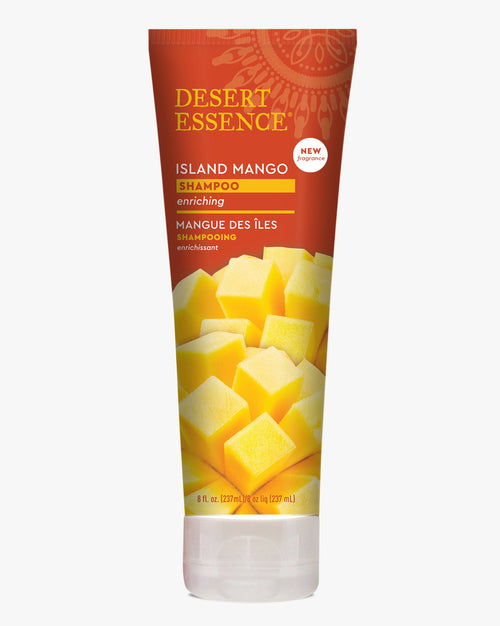 Desert Essence Island Mango Shampoo bottle featuring vibrant orange packaging with yellow mango cubes design, showcasing an enriching natural hair care product with tropical aesthetics