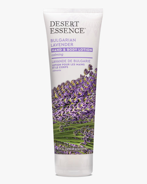 Desert Essence Bulgarian Lavender Hand & Body Lotion in a white tube with calming purple lavender flowers and green stems decorating the packaging, featuring organic skincare ingredients and bilingual English-French labeling