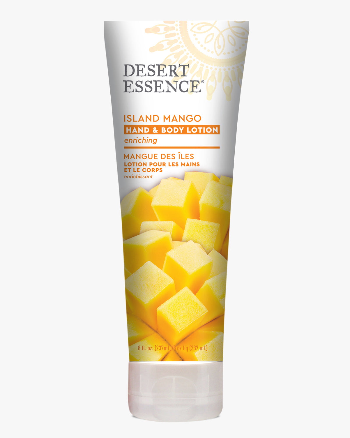 Desert Essence Island Mango Hand & Body Lotion tube featuring vibrant yellow mango cubes on the packaging, with silver and orange text against a white background. The enriching moisturizer showcases both English and French product descriptions.