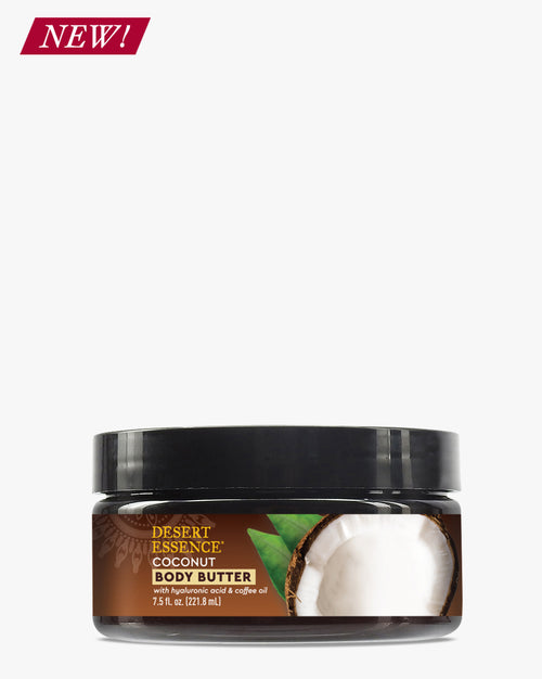 Coconut Body Butter in a round black jar with brown label featuring fresh coconut imagery, against white background. Desert Essence brand natural moisturizer for smooth, hydrated skin.