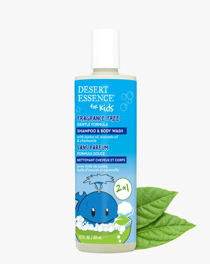 Desert Essence Fragrance Free Kids 2in1 Shampoo & Body Wash bottle with gentle formula, featuring a blue cartoon whale design and natural green leaves, against a white background. Clear bottle with white cap contains nourishing blend of jojoba and avocado oils.