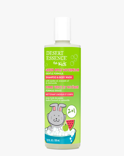 Green Apple Watermelon Kids 2in1 Shampoo & Body Wash bottle featuring a bright green label with cartoon bunny and fruit illustrations. Natural formula in white plastic container with Desert Essence kids branding and bilingual text.