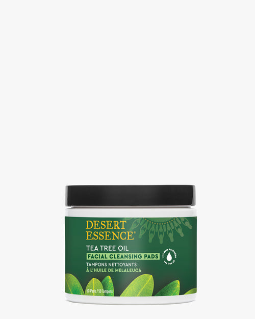 Tea Tree Oil Facial Cleansing Pads by Desert Essence in white jar with green label, featuring botanical leaf design and eco-friendly product information on front panel